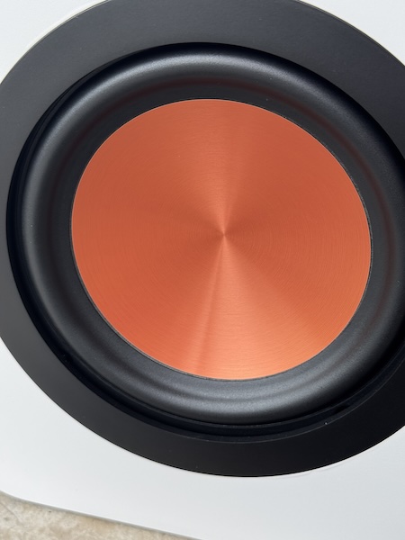 HybridCone woofer close‑up — paper core with alloy outer layer