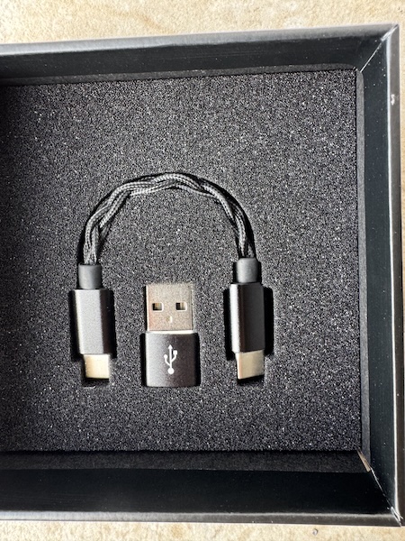 USB cable and adapter underneath tray