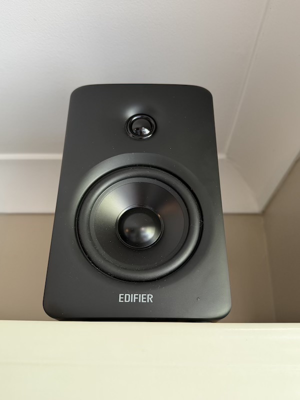 M90 placed on top of a bookshelf and angled down toward the listening position