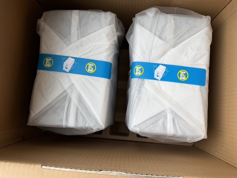 speakers in protective covers inside the box