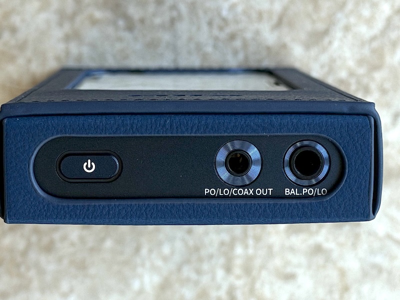 top view with case on — 3.5mm and 4.4mm outputs remain accessible