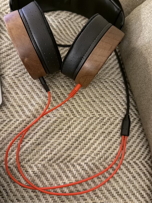 x1 on the chair — a handsome open-back studio headphone