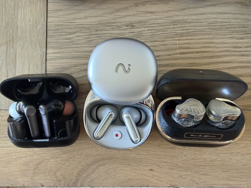 case comparison — EarFun Air Pro 4 (left), H3 (centre), Status Pro X (right)