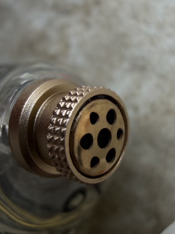 nozzle grille close-up showing the acoustic porting