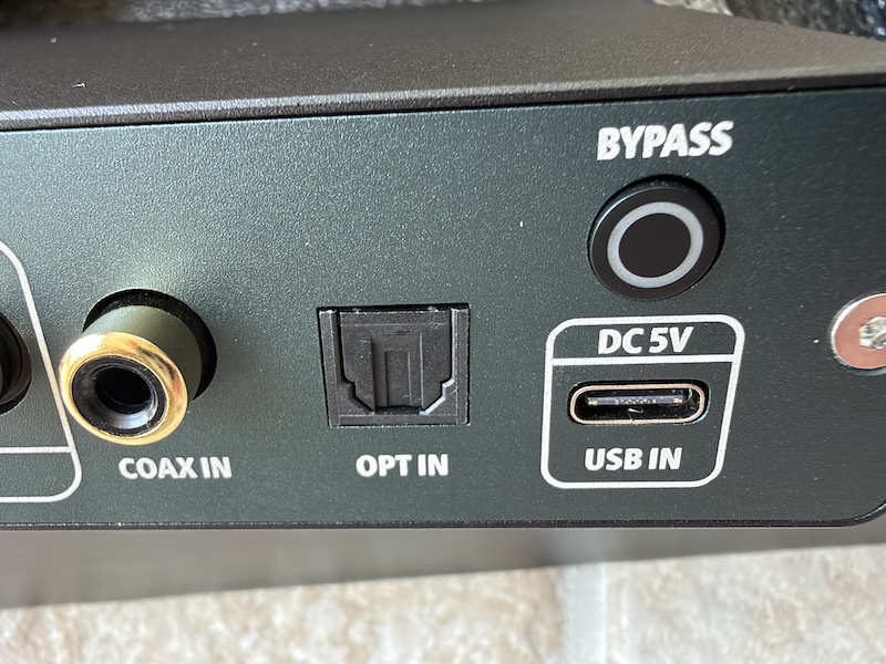 the D07’s rear panel — RCA outputs for CH1 and CH2, the UAC button, coaxial in, optical in, and USB-C in with the Bypass button