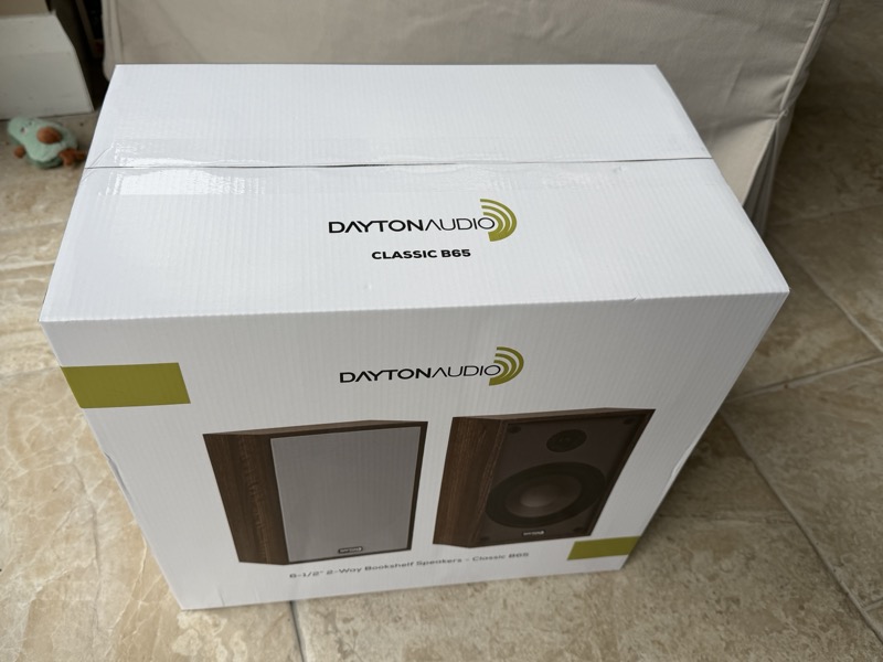 the retail box front, showing a photo of the speaker pair