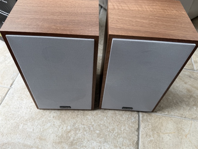 the speaker pair unwrapped, sitting side by side with grilles on