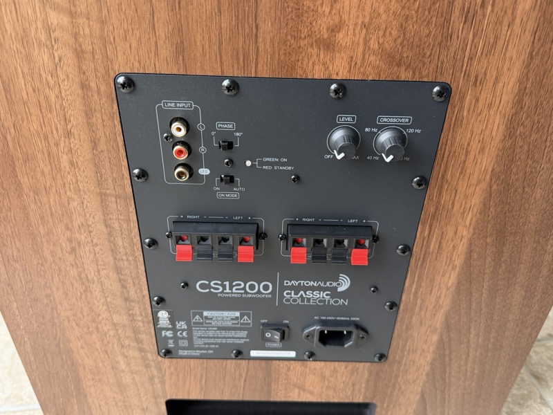 the rear panel, showing the RCA and LFE inputs, speaker-level terminals, and the level, crossover and phase controls