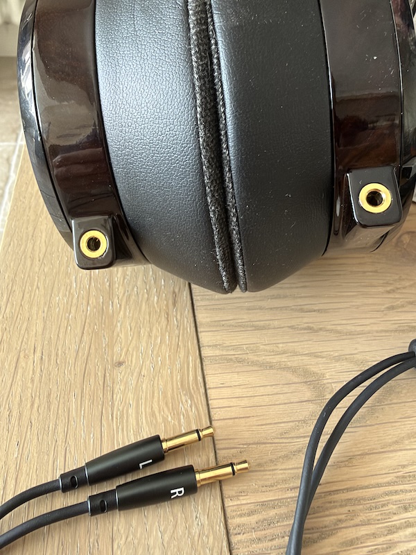 the two gold-ringed 3.5mm sockets on the underside of the earcups, with the L and R marked plugs alongside