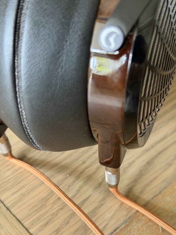 a closer look at the zebrawood earcup’s gloss finish where it meets the aluminium frame and cable exit