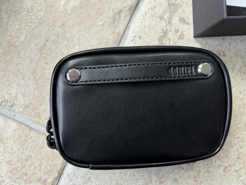 the case, showing the zip and stitched strap detail