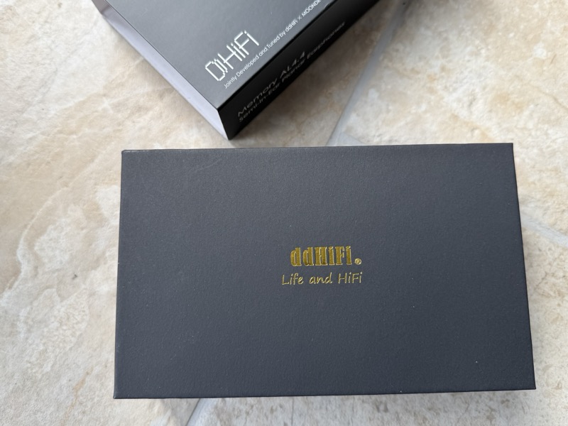 the inner box, printed with ddHiFi’s “Life and HiFi” branding, sitting beside the outer sleeve