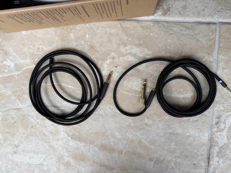 the two supplied cables — 4.4mm balanced and 3.5mm with a 6.35mm screw-on adapter