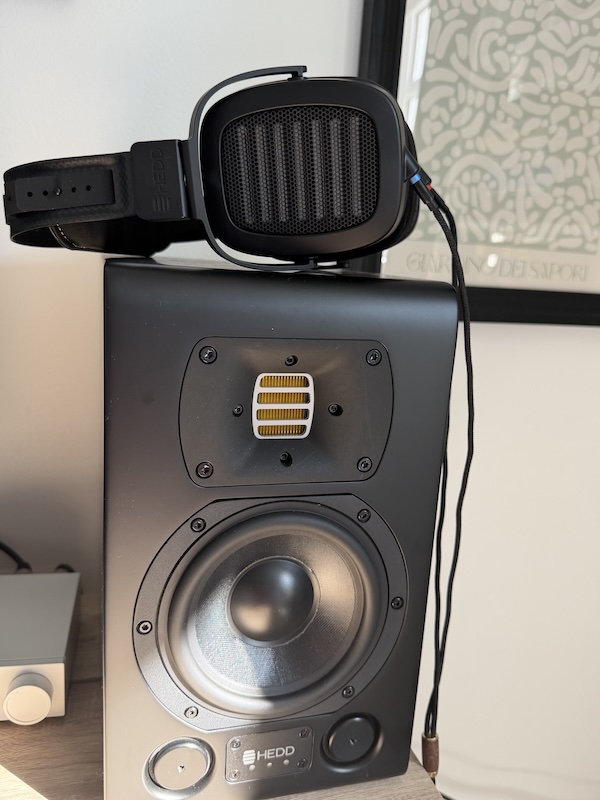 the HEDDphone TWO GT resting on top of a HEDD studio monitor at the desk