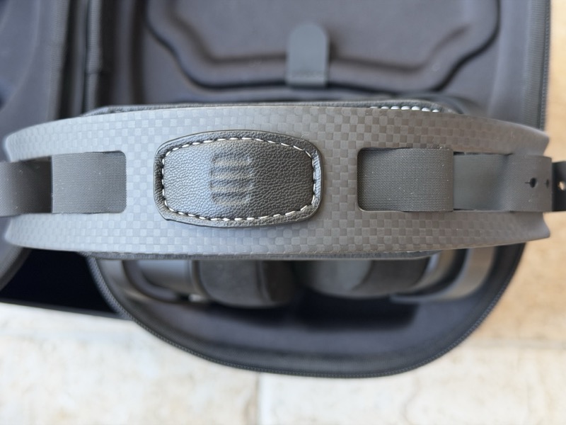 a stitched and embossed detail panel at the centre of the headband