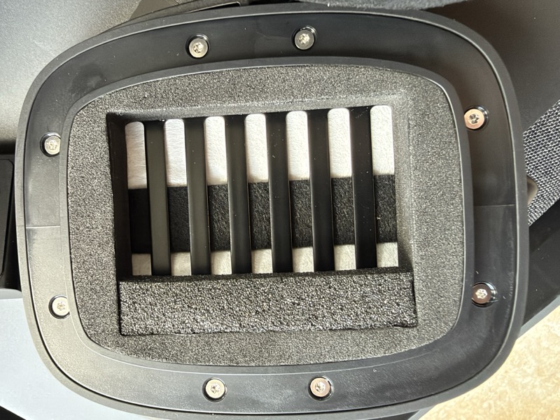 the rectangular AMT driver, showing the pleated ribbon diaphragm through the grille