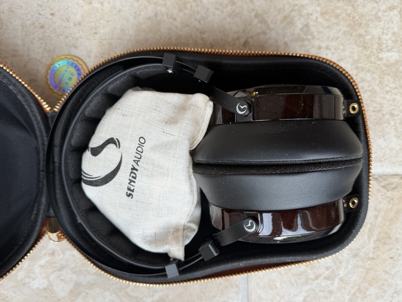the headphone in its case with the linen accessory bag