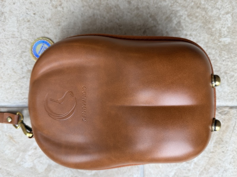 the case exterior, showing the embossed sendy audio logo and brass fittings