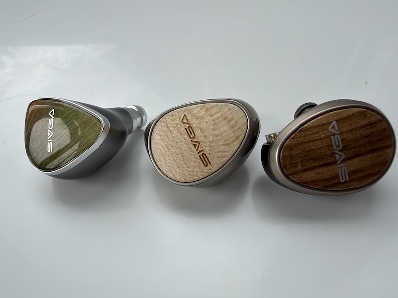 the Lyrebird, the Que and the Nightingale Pro side by side, showing three takes on the wood faceplate