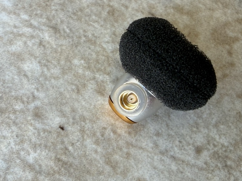 earbud driver grille face closeup