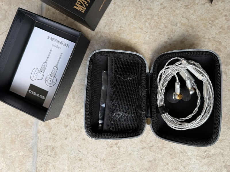 earphones in open case with manual