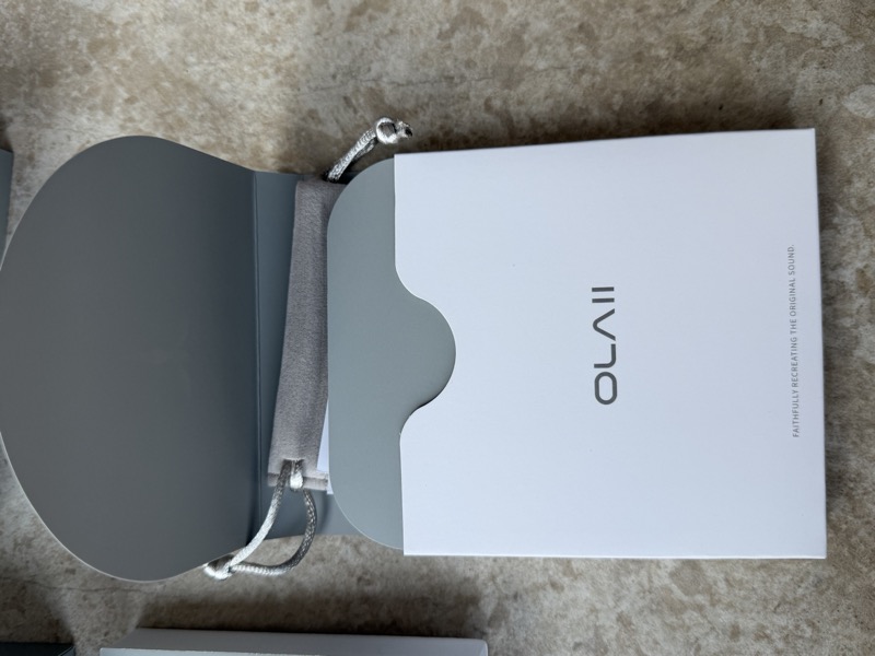 inner box opened showing the nested OLAII compartment and drawstring pouch