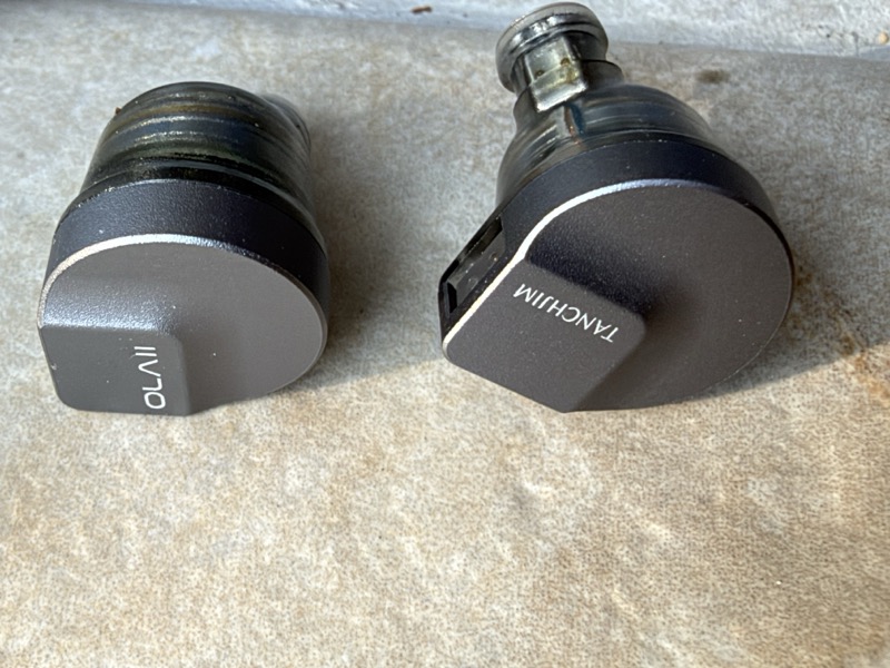 closeup of both shells showing the OLAII and TANCHJIM faceplate markings
