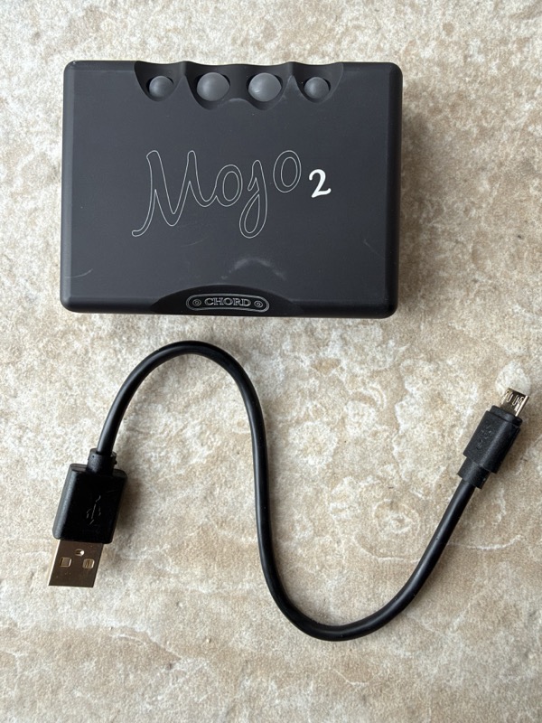 chord mojo 2 beside the supplied usb-a to micro-usb charging cable