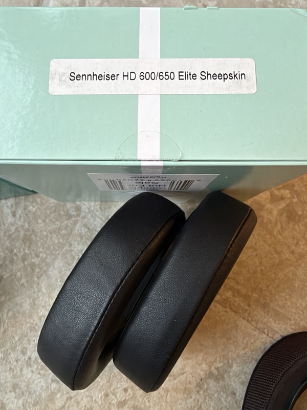 elite sheepskin pads leaning against the pale green elite box