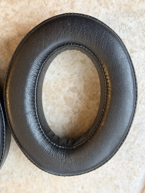 close-up of the inner wall of a dekoni leather pad showing a smooth unperforated surface and stitched seam