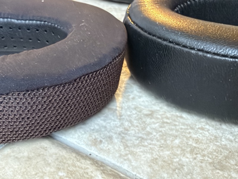 stock hd600 pad with woven side band beside the thicker dekoni leather pad