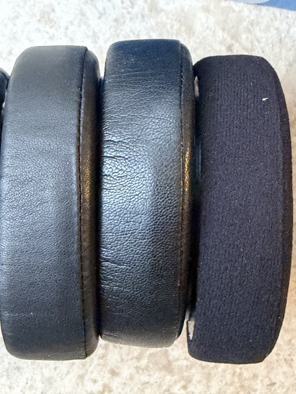 three dekoni pads photographed from the side showing the leather pads thicker than the velour pad