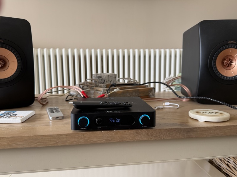 the air amp on a shelf between kef ls50 meta speakers