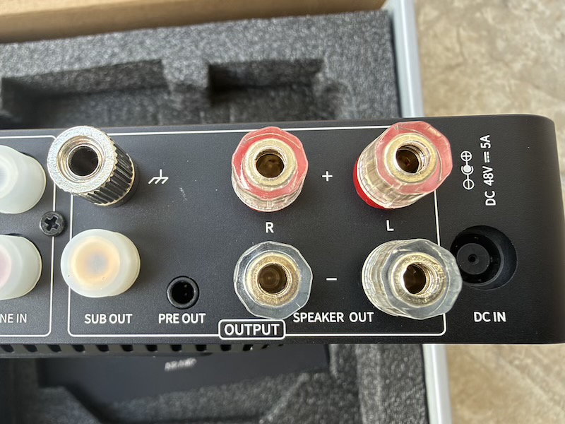 output side: sub out, pre out, speaker binding posts and 48v dc inlet