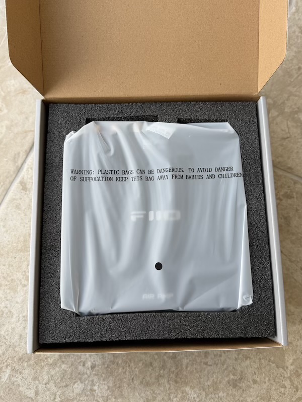 the air amp sealed in its foam tray