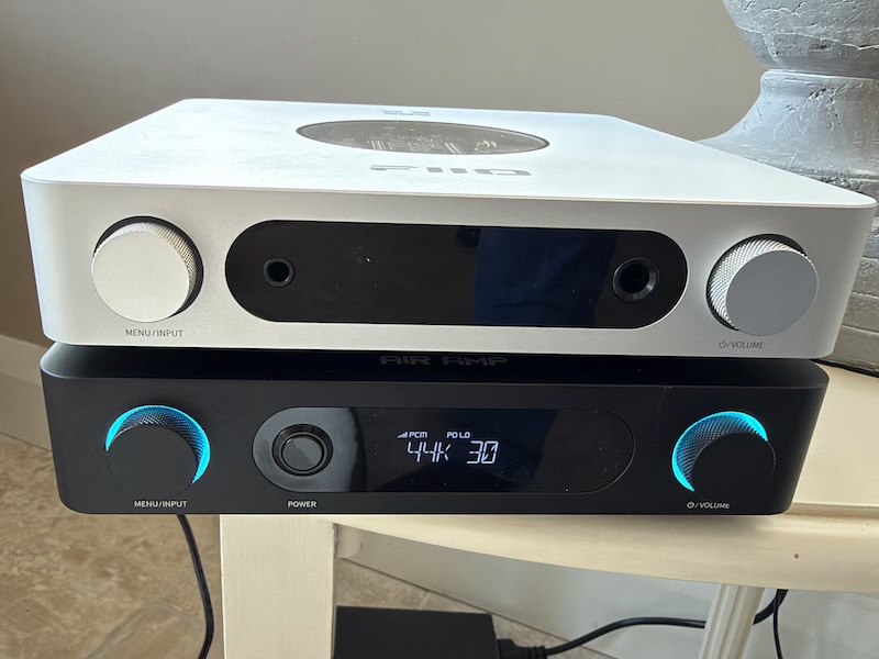 the fiio air amp under a silver fiio k13 r2r, front panels