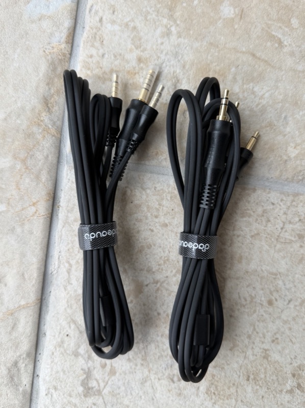 the jt9’s two headphone cables coiled, one terminated in 3.5mm and one in 4.4mm, both with dual 3.5mm plugs at the headphone end