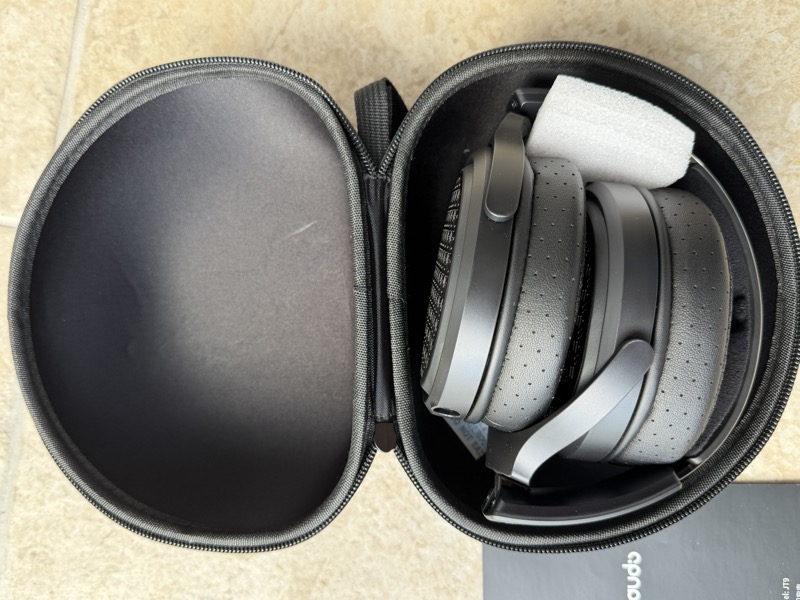 jt9 headphones folded flat inside the open hard carry case