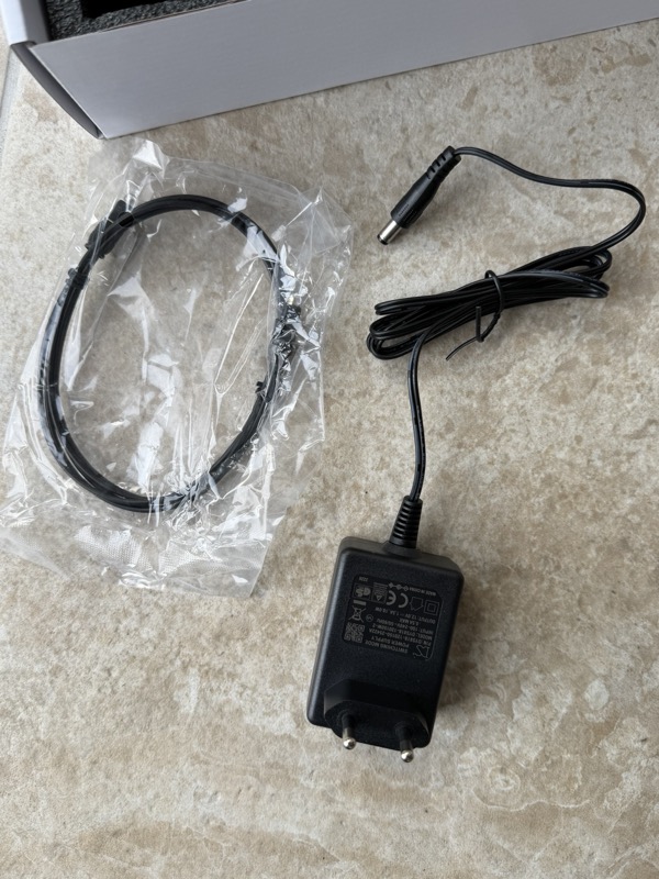 the bundled ethernet cable and two-pin 12v power supply