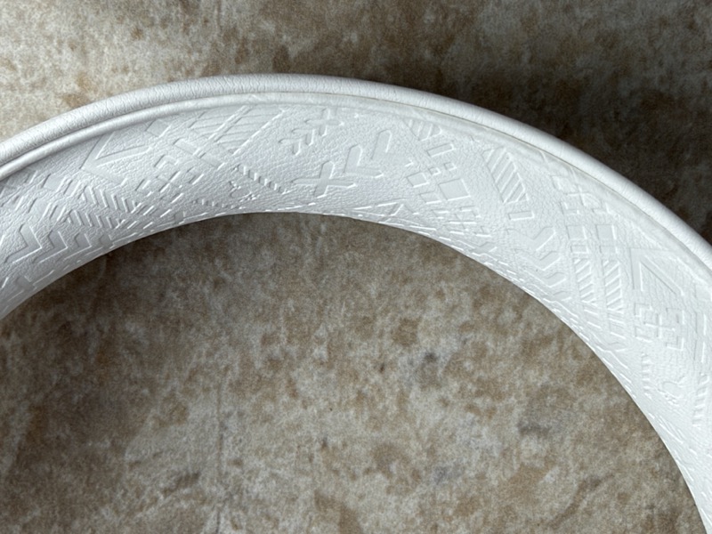close-up of the embossed geometric pattern in the white headband