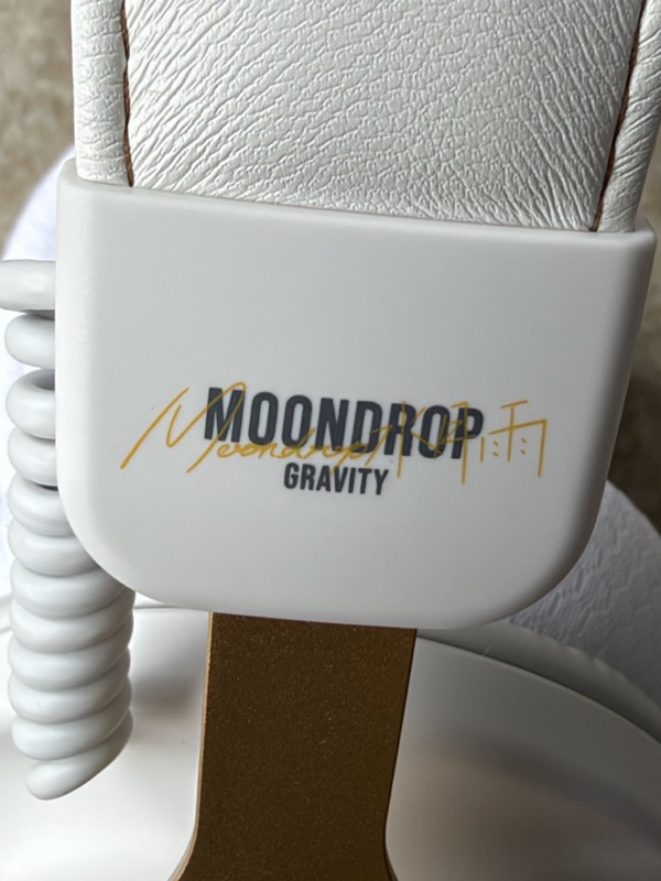 the headband slider block where the band meets the gold yoke arm, with moondrop gravity branding